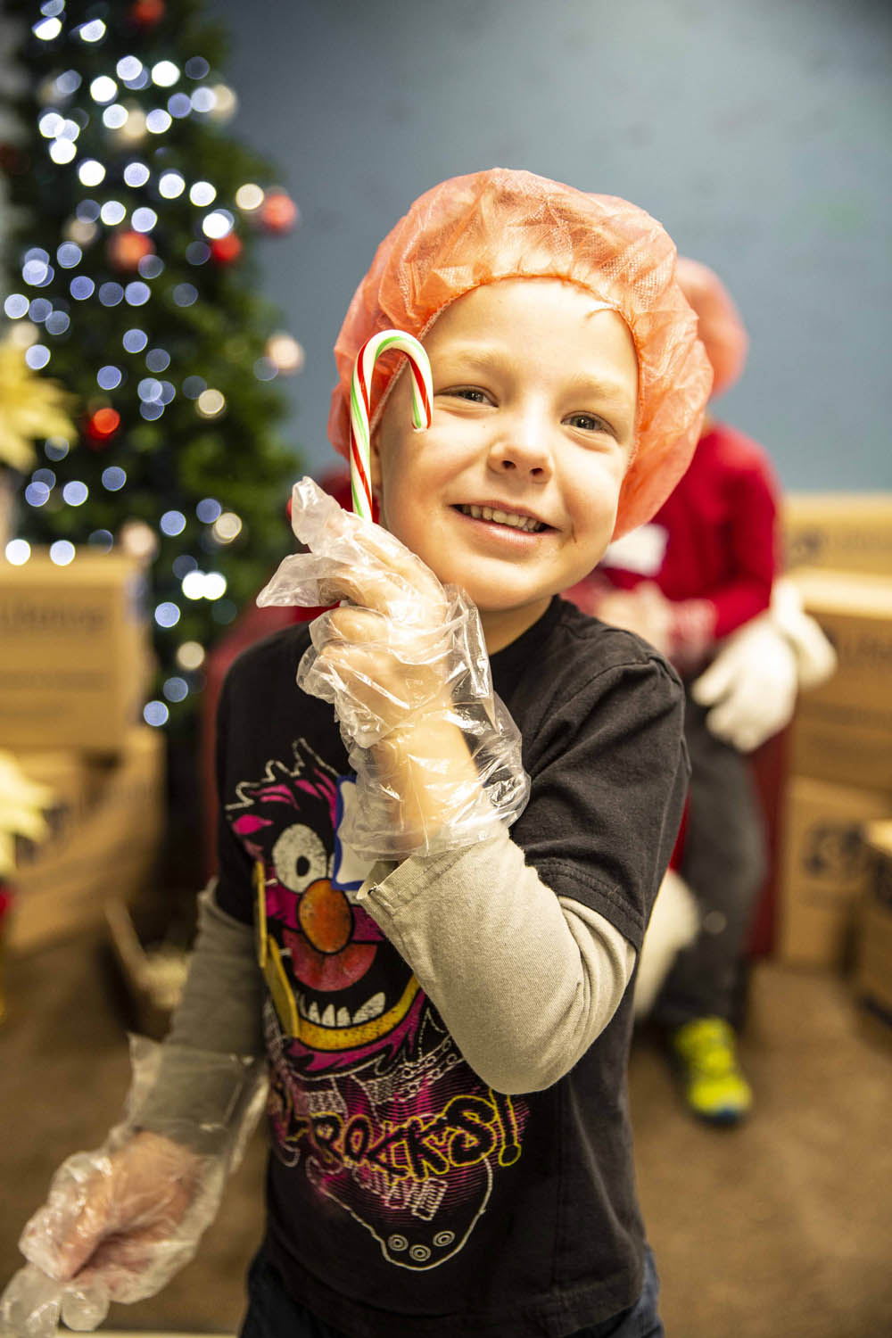 Lifeline Christmas Event - Smiling Boy with Candy Cane